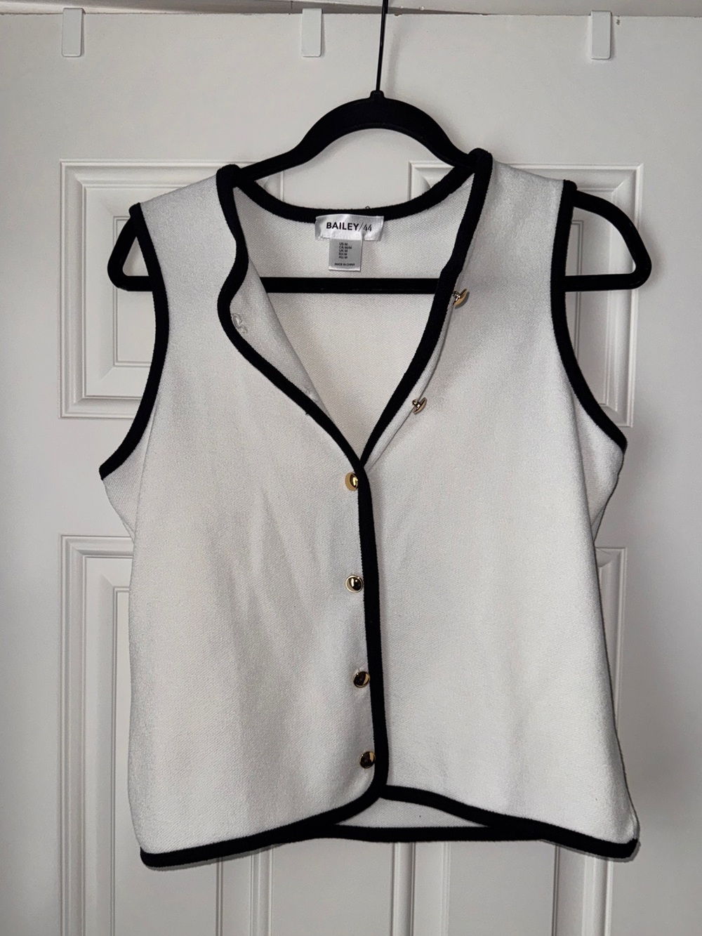 White Sleeveless Button Vest with Black Trim and Gold Buttons
